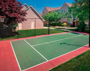 The hotel’s basketball court is located next to the patio, with lush lawns on either side.