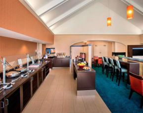 The breakfast area in Sonesta ES Suites Allentown Bethlehem Airport has a mix of table and tall stool seating, and a range of healthy eating options.