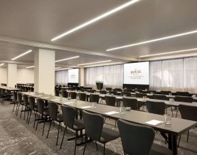 Large meeting room in Royal Sonesta Minneapolis Downtown, with lectern, large screens, and space for seating for several dozen attendees.
