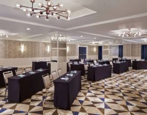 Large meeting room in Royal Sonesta Washington DC Dupont Circle, with tables of three seats each arranged in a classroom style.