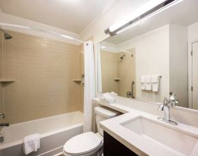 Sonesta Simply Suites Albuquerque guest bathroom has a sink and shower, as well as a bathtub and lavatory.