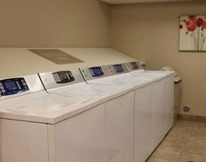 The hotel’s laundry room has numerous machines for guests to use, and art on the wall.