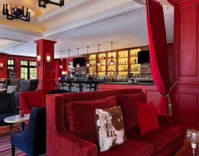The Stephen F Austin Royal Sonesta Hotel’s bar has vibrant red decor, and a mix of comfortable table seating and traditional bar stools.