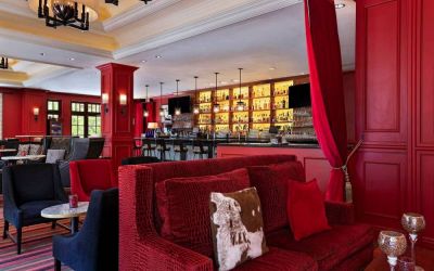 The Stephen F Austin Royal Sonesta Hotel’s bar has vibrant red decor, and a mix of comfortable table seating and traditional bar stools.