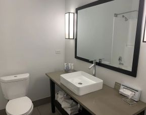 Guest bathroom with shower at Country Inn & Suites By Radisson, Chicago O'Hare South.