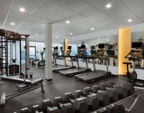 The hotel fitness center has rows of free weights, both dumbbells and kettlebells, and an assortment of exercise machines.