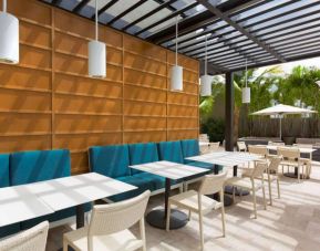 The hotel patio features tables and chairs where guests can relax and socialize in the open air.