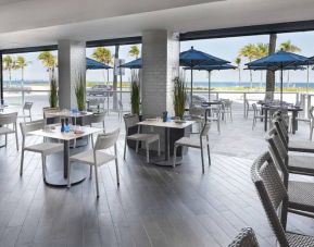 Sonesta Fort Lauderdale Beach’s Steelpan Restaurant serves up Caribbean-American fusion fare, with small tables, a hard floor and ocean views.