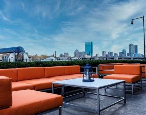 Royal Sonesta Boston’s patio provides comfortable outdoor seating and large coffee tables.