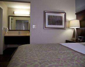 Sonesta ES Suites Sunnyvale double bed guest room, featuring art on the wall and an ensuite bathroom.