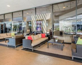 Sonesta Los Angeles Airport LAX’s lobby lounge features comfy sofa and armchair seating, and large coffee tables.