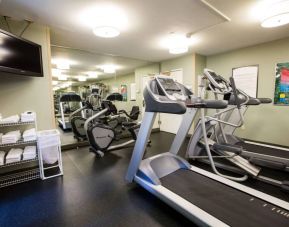 The fitness center at Sonesta ES Suites Austin The Domain Area includes a widescreen television, plenty of towels, and multiple exercise machines.
