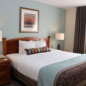 Sonesta ES Suites Portland Vancouver 41st Street double bed guest room, featuring art on the wall and a large window.