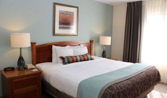 Sonesta ES Suites Portland Vancouver 41st Street double bed guest room, featuring art on the wall and a large window.