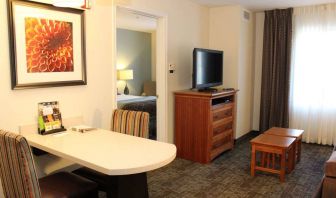 Sonesta ES Suites Portland Vancouver 41st Street guest room, furnished with double bed, desk and chairs, and a widescreen TV.