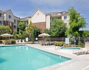 Sonesta ES Suites Portland Vancouver 41st Street’s outdoor pool has a nearby hot tub, with sun loungers, and shaded tables and chairs in the vicinity.