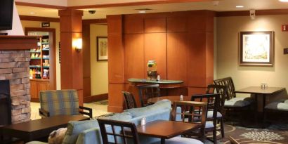 Sonesta ES Suites Portland Vancouver 41st Street’s lobby has extensive seating and numerous small tables.