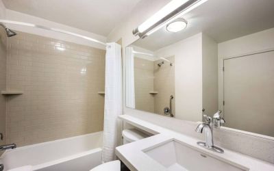 Sonesta Simply Suites Salt Lake City Airport guest bathroom, furnished with sink lavatory, and bathtub (including shower).