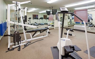 Sonesta Simply Suites Salt Lake City Airport’s fitness center has a diverse array of exercise machines and a television set.