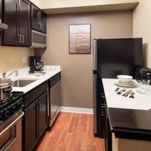 Sonesta Simply Suites Seattle Renton guest room kitchen, furnished with oven, hob, microwave, and fridge-freezer.