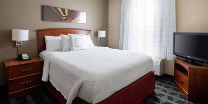 Double bed guest room in Sonesta Simply Suites Seattle Renton, featuring a large window and widescreen television.