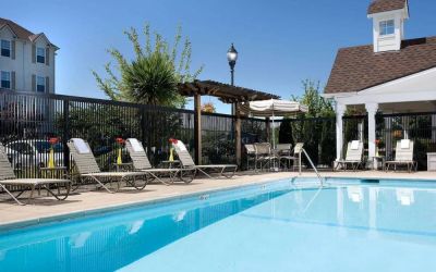 Sonesta Simply Suites Seattle Renton’s outdoor pool is fenced off and has both sun loungers and chairs by the side.