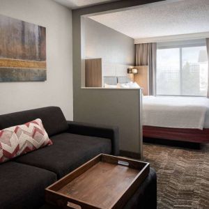 Sonesta Select Seattle Renton double bed guest room, featuring TV, window, and sofa.
