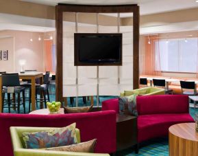 Sonesta Select Seattle Renton’s lobby lounge has comfortable seating, coffee tables, and a wall-mounted TV.