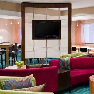 Sonesta Select Seattle Renton’s lobby lounge has comfortable seating, coffee tables, and a wall-mounted TV.