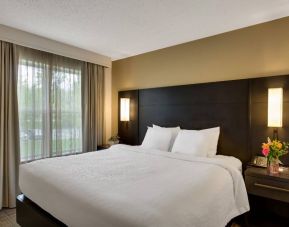 Double bed guest room in Sonesta ES Suites Parsippany Morris Plains, with bedside lighting and a large window.