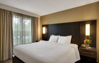 Double bed guest room in Sonesta ES Suites Parsippany Morris Plains, with bedside lighting and a large window.