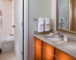 Sonesta ES Suites Birmingham Homewood guest bathroom, with sink, mirror, and bath (including shower).