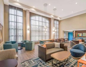 The hotel’s lobby lounge has a high ceiling and full-length windows, comfortable seating including armchairs and sofas, and numerous coffee tables.