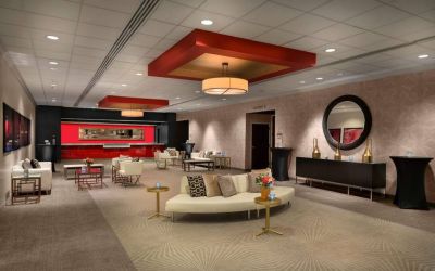 The lounge in Sonesta Philadelphia Rittenhouse Square’s lobby is furnished with sofas and comfy chairs, numerous coffee tables, and is a spacious setting.