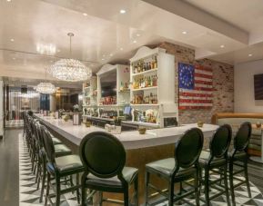 The hotel restaurant has tall stool seating at the bar, an extensive range of beverages, and an artistic 13 star Betsy Ross variant of the Stars and Stripes on the wall.