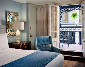 Double bed guest room in Royal Sonesta New Orleans, including armchair and a balcony.