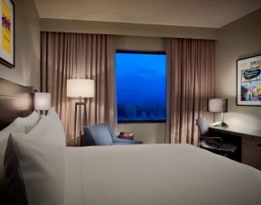 Double bed guest room in Sonesta Bee Cave Austin, with a window and workspace desk, lamp, and chair.