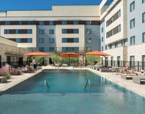 Sonesta Bee Cave Austin’s outdoor pool has sun loungers by the side and shaded seating just a few feet away.