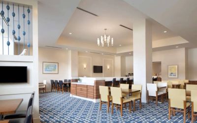 Sonesta ES Suites New Orleans’s cozy social space, The Nest, is the perfect place to rest and relax at tables large and small, or watch one of the wall-mounted televisions.