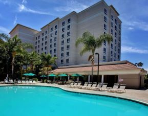 Outdoor pool with pool chairs at Sonesta Anaheim Resort Area.