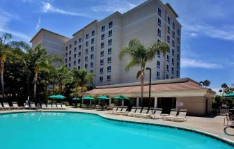 Outdoor pool with pool chairs at Sonesta Anaheim Resort Area.