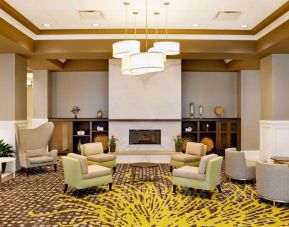 The hotel’s lobby lounge includes a fireplace, armchairs and coffee tables set in a spacious environment.