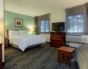 Double bed guest room in Sonesta ES Suites Anaheim Resort Area, including two windows, coffee table, and a television.