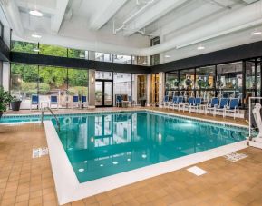 The hotel’s indoor pool includes a lift, has chairs by the side, and large windows to let in plenty of natural light.