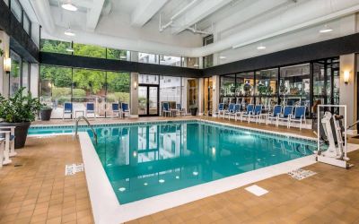The hotel’s indoor pool includes a lift, has chairs by the side, and large windows to let in plenty of natural light.