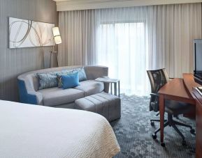 Delux king room with couch and workspace at Sonesta Select Milwaukee Brookfield.