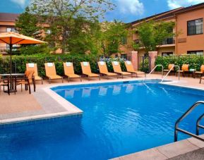 The hotel’s outdoor pool has a direct water link to the indoor pool, and has a shaded table and chairs as well as sun loungers by the side.