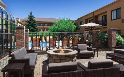 Sonesta Select Newport Middletown’s fire pit has comfortable armchair and sofa seating nearby, and is close to the pool.