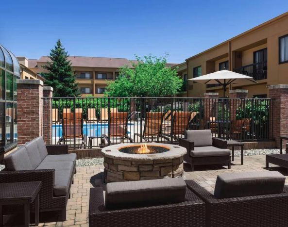 Sonesta Select Newport Middletown’s fire pit has comfortable armchair and sofa seating nearby, and is close to the pool.