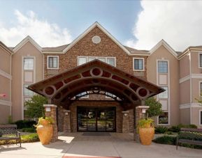 Sonesta ES Suites San Antonio Northwest - Medical Center’s exterior has pleasant greenery and benches, and a covered entranceway.